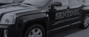close up of sentinel security enforcement logo on side of suv