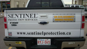 white sentinel protection services truck rear view
