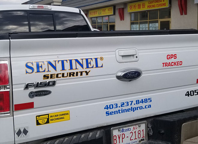sentinel protection services white pickup truck rear view