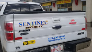white sentinel protection services truck rear view