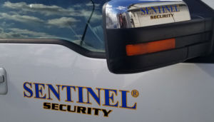 zoom in on sentinel security logo on white truck