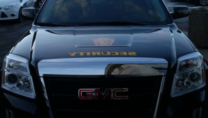 front view of GMC truck with the word security backwards on the hood