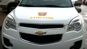 zoomed in front view of white sentinel security suv