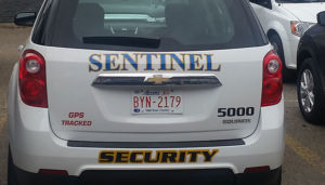 zoom of rear view of sentinel security white suv