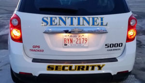 zoomed rear view of white sentinel security suv 5000