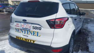 rear view of sentinel security white suv 5010