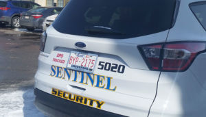 rear view of sentinel security white suv 5020