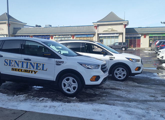two sentinel security white suvs 5020 and 5010