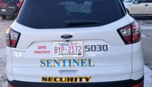 rear view of sentinel security white suv 5030