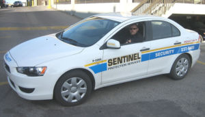 sentinel security white 4 door car number p-2060
