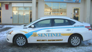 sentinel security white 4 door car number 4000