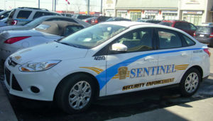 sentinel security white 4 door car number 4010