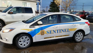 sentinel security white 4 door car number 4040